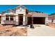 New home under construction showcasing the facade and roof tile installation, with a spacious garage and future landscaped yard at 30316 N Acacia Dr, Florence, AZ 85132