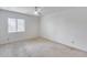 Neutral bedroom with carpeted floors, white walls, a window, and simple design at 319 E Hackamore St, Mesa, AZ 85201