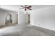 Spacious bedroom with neutral carpeting, ample natural light, and seamless access to the bathroom at 319 E Hackamore St, Mesa, AZ 85201