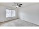 Neutral bedroom with a ceiling fan, carpeted floors, white walls, and window at 319 E Hackamore St, Mesa, AZ 85201