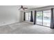 Bright bedroom featuring carpeted floors and sliding glass doors leading to a backyard swimming pool at 319 E Hackamore St, Mesa, AZ 85201