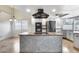 Modern kitchen with gray and white cabinets, stainless steel appliances, and a kitchen island at 319 E Hackamore St, Mesa, AZ 85201