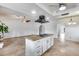 Open kitchen with an island, stainless steel appliances, tiled floors, and access to the living room at 319 E Hackamore St, Mesa, AZ 85201