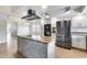 Modern kitchen with gray and white cabinets, stainless steel appliances, and a kitchen island at 319 E Hackamore St, Mesa, AZ 85201