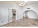Bright living room featuring tiled flooring, a chandelier, and an arched doorway at 319 E Hackamore St, Mesa, AZ 85201