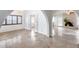 Bright living room featuring tiled floors, arched doorways, shutters, and natural light at 319 E Hackamore St, Mesa, AZ 85201