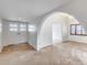 Bright living room featuring tile flooring, arched doorway, and a modern chandelier at 319 E Hackamore St, Mesa, AZ 85201