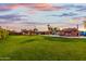 Sprawling backyard showcasing a pool, covered patios, and lush lawn, perfect for outdoor living and entertainment at 368 E Campbell Rd, Chandler, AZ 85225