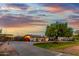 An exterior view shows a home with an arched entryway and a long driveway leading to a gated area at 368 E Campbell Rd, Chandler, AZ 85225