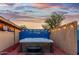 Relaxing hot tub on a wooden deck, nestled within a fenced yard and enhanced with ambient string lighting at 368 E Campbell Rd, Chandler, AZ 85225