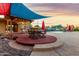 Inviting outdoor dining area with a covered patio, seating, and views of the pool and landscaped backyard at 368 E Campbell Rd, Chandler, AZ 85225