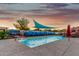Beautiful in-ground pool area with a decorative desert landscape fence, water features, and shaded seating at 368 E Campbell Rd, Chandler, AZ 85225
