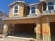 New construction featuring a two-story structure with an open garage and visible framing, windows, and raw building materials at 5836 E Covey Ln, Phoenix, AZ 85054