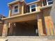 Exterior view of a new construction home showing the framing and sheathing and an attached two-car garage at 5852 E Covey Ln, Phoenix, AZ 85054