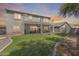 Expansive backyard showcasing lush artificial turf, a fenced patio, and the home's exterior, ideal for outdoor activities at 11259 W Locust Ln, Avondale, AZ 85323