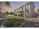 View of a two-story home with balconies and a large, well-maintained backyard with a pool, perfect for outdoor living at 11259 W Locust Ln, Avondale, AZ 85323
