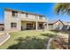 Expansive backyard featuring a grassy lawn, covered patios, and wrought-iron fencing at 11259 W Locust Ln, Avondale, AZ 85323