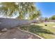 Spacious backyard with artificial turf and a block fence, offering a private and low-maintenance outdoor space at 11259 W Locust Ln, Avondale, AZ 85323