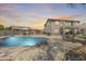Private backyard oasis with a sparkling pool, lounge chairs, and a covered patio at 11259 W Locust Ln, Avondale, AZ 85323