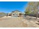 Wide backyard view showcasing the pools, patios, and desert landscaping, providing a private outdoor space at 11259 W Locust Ln, Avondale, AZ 85323