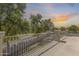 Large balcony overlooking lush trees and street, perfect for relaxation and enjoying the outdoor scenery at 11259 W Locust Ln, Avondale, AZ 85323