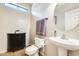 Stylish powder room featuring a pedestal sink, modern fixtures, and tiled flooring at 11259 W Locust Ln, Avondale, AZ 85323