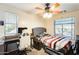 Bedroom with a modern ceiling fan, lots of natural light, and a gaming desk at 11259 W Locust Ln, Avondale, AZ 85323