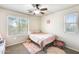 This bedroom is bathed in natural light and includes a ceiling fan at 11259 W Locust Ln, Avondale, AZ 85323
