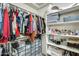 Well-organized walk-in closet with shelving for shoes, clothes, and accessories at 11259 W Locust Ln, Avondale, AZ 85323