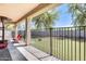 Cozy covered patio overlooks a fenced yard with artificial grass, offering a tranquil outdoor living space at 11259 W Locust Ln, Avondale, AZ 85323