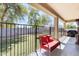 Covered patio features a comfortable seating area overlooking the manicured artificial grass yard at 11259 W Locust Ln, Avondale, AZ 85323