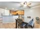Eat-in kitchen area features a modern table, chairs, and a view of kitchen cabinets at 11259 W Locust Ln, Avondale, AZ 85323