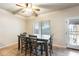 Dining area features a modern table and chairs, complemented by a ceiling fan at 11259 W Locust Ln, Avondale, AZ 85323