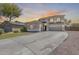 Charming two-story home with a well-maintained front yard and a long driveway leading to a spacious three-car garage at 11259 W Locust Ln, Avondale, AZ 85323