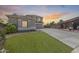 Charming single-Gathering home with lush front lawn and a long driveway leading to a spacious garage, creating curb appeal at 11259 W Locust Ln, Avondale, AZ 85323