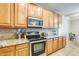 Modern kitchen featuring sleek appliances, granite countertops, and wooden cabinets at 11259 W Locust Ln, Avondale, AZ 85323