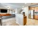 Open-concept layout featuring kitchen with granite countertops, seamlessly flowing into the living area at 11259 W Locust Ln, Avondale, AZ 85323