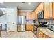 Well-lit kitchen featuring stainless steel appliances, granite countertops, and wood cabinetry at 11259 W Locust Ln, Avondale, AZ 85323