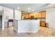 Stylish kitchen featuring wooden cabinetry, tile floors, and an open layout connecting to the living area at 11259 W Locust Ln, Avondale, AZ 85323