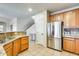 Functional kitchen featuring stainless steel appliances, granite countertops, and natural wood cabinets at 11259 W Locust Ln, Avondale, AZ 85323
