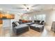 Open-concept living room featuring a large gray sectional sofa and seamless transition to the dining area at 11259 W Locust Ln, Avondale, AZ 85323