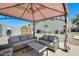 Outdoor patio area featuring cushioned seating beneath a shaded pergola, creating a comfortable lounge space at 11259 W Locust Ln, Avondale, AZ 85323