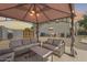 Cozy outdoor patio with comfortable seating under a gazebo, ideal for entertaining and relaxation at 11259 W Locust Ln, Avondale, AZ 85323