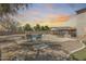 Inviting pool area surrounded by ample seating, lush landscaping, and a cozy gazebo, perfect for outdoor relaxation at 11259 W Locust Ln, Avondale, AZ 85323