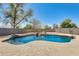 Private backyard pool with rock waterfall feature and desert landscape at 11259 W Locust Ln, Avondale, AZ 85323