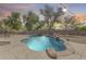 Beautifully landscaped pool area with a rock waterfall feature, creating a serene and inviting outdoor oasis at 11259 W Locust Ln, Avondale, AZ 85323