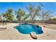 Backyard pool featuring rock accents, a small waterfall, and ample patio space for outdoor enjoyment at 11259 W Locust Ln, Avondale, AZ 85323