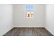 Bright bedroom featuring wood-look floors and a window showing an exterior view at 12246 E Agave Ln, Florence, AZ 85132