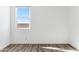 Empty bedroom showcases wood floors, bright walls, and window overlooking outside perimeter wall at 12246 E Agave Ln, Florence, AZ 85132