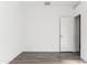 Bright bedroom featuring wood-look floors and a white door at 12246 E Agave Ln, Florence, AZ 85132